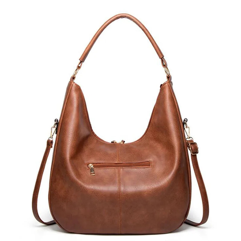 Ysolde leather hobo bag in brown, back view with zip pocket