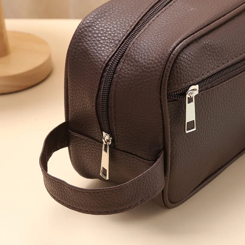 Anwen toiletry bag in brown, close-up of zip and carry strap