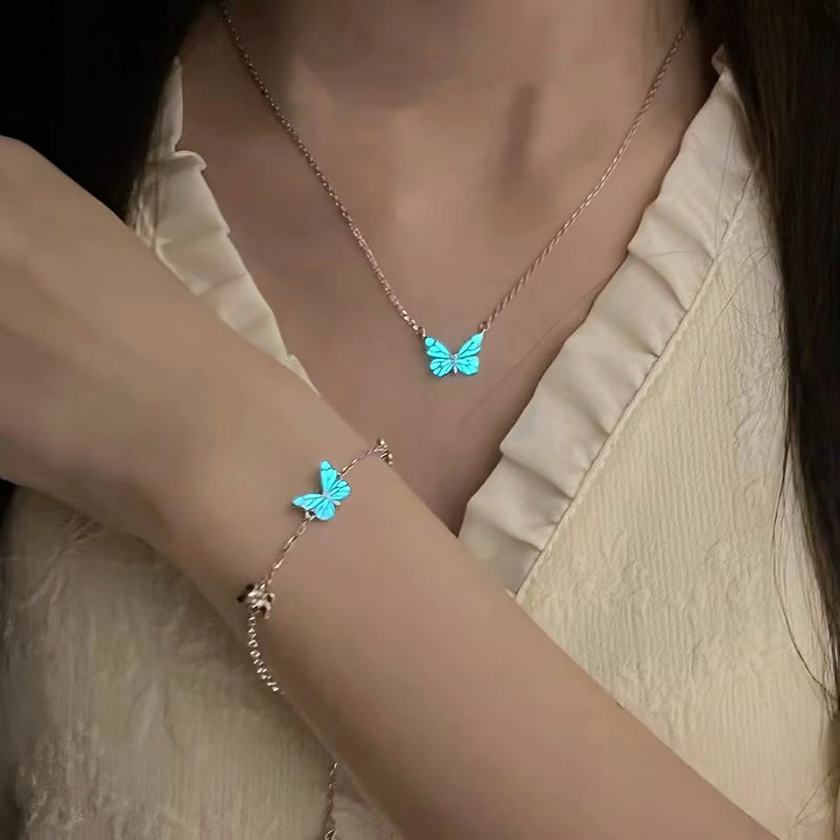 Butterfly bracelet glowing blue in the dark on the wrist