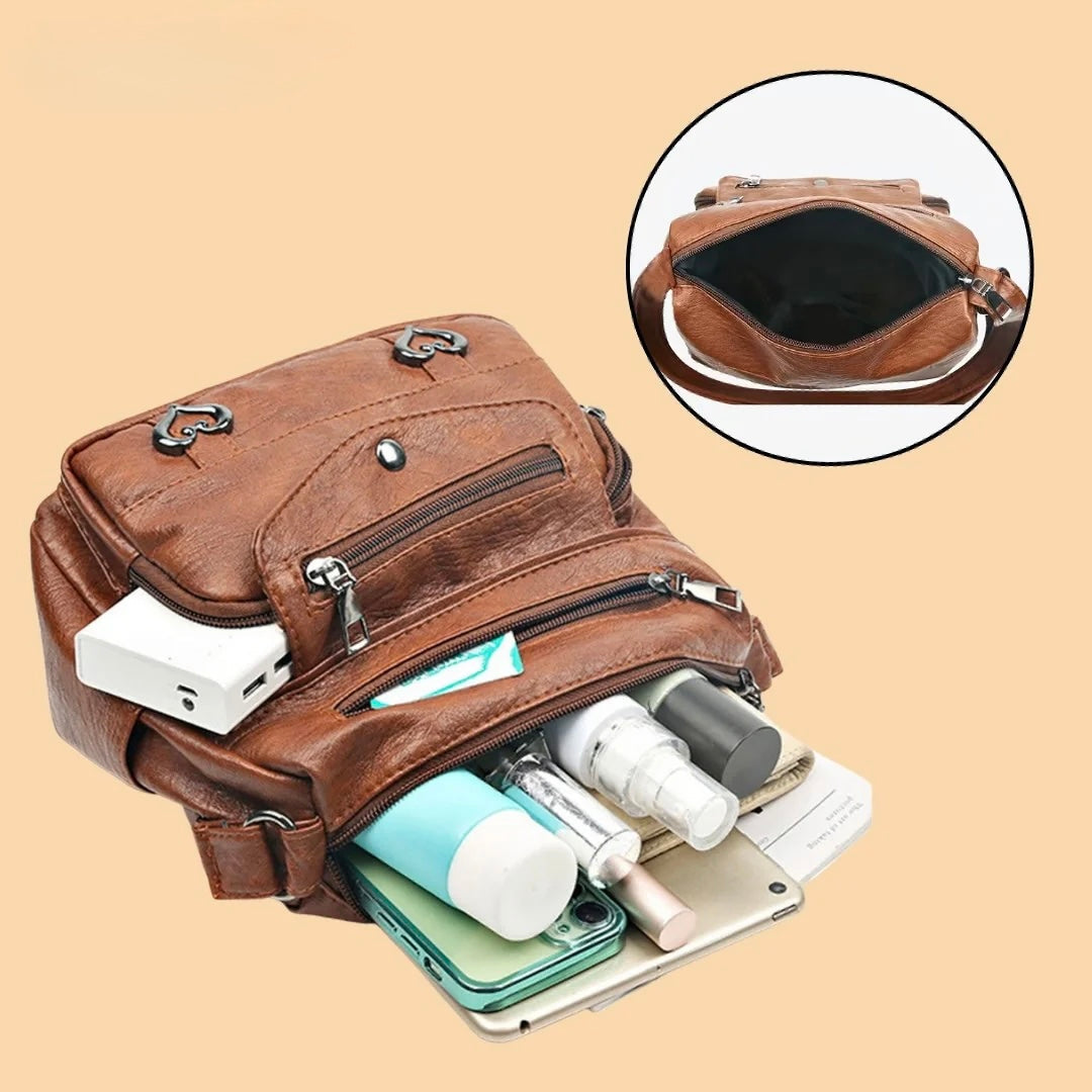 Verona crossbody bag in brown shown with pockets filled with everyday essentials