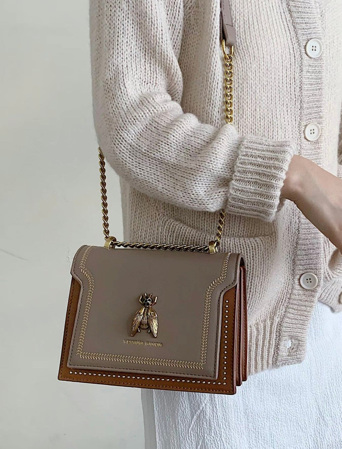 Simone chain bag in khaki, crossbody front view with cardigan