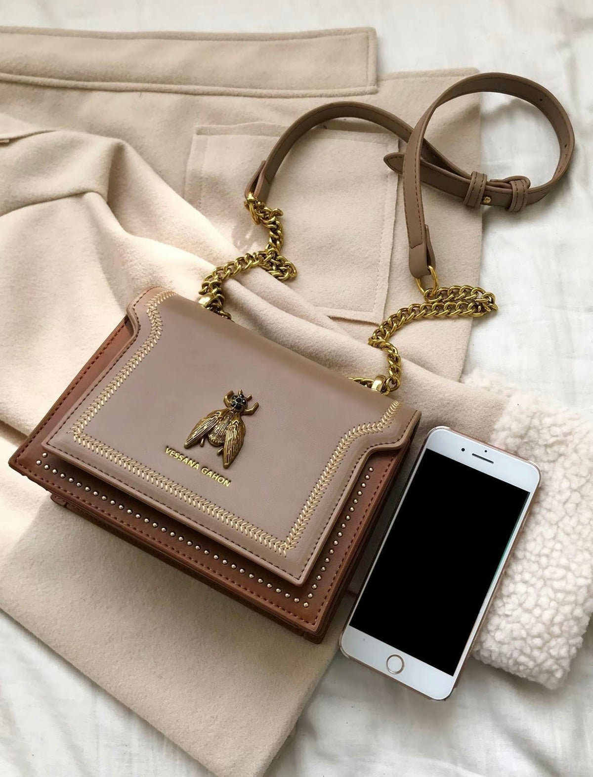 Simone chain bag in khaki, flat lay beside a phone