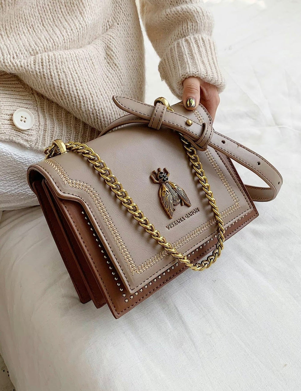 Simone chain bag in khaki, held close-up with gold chain strap