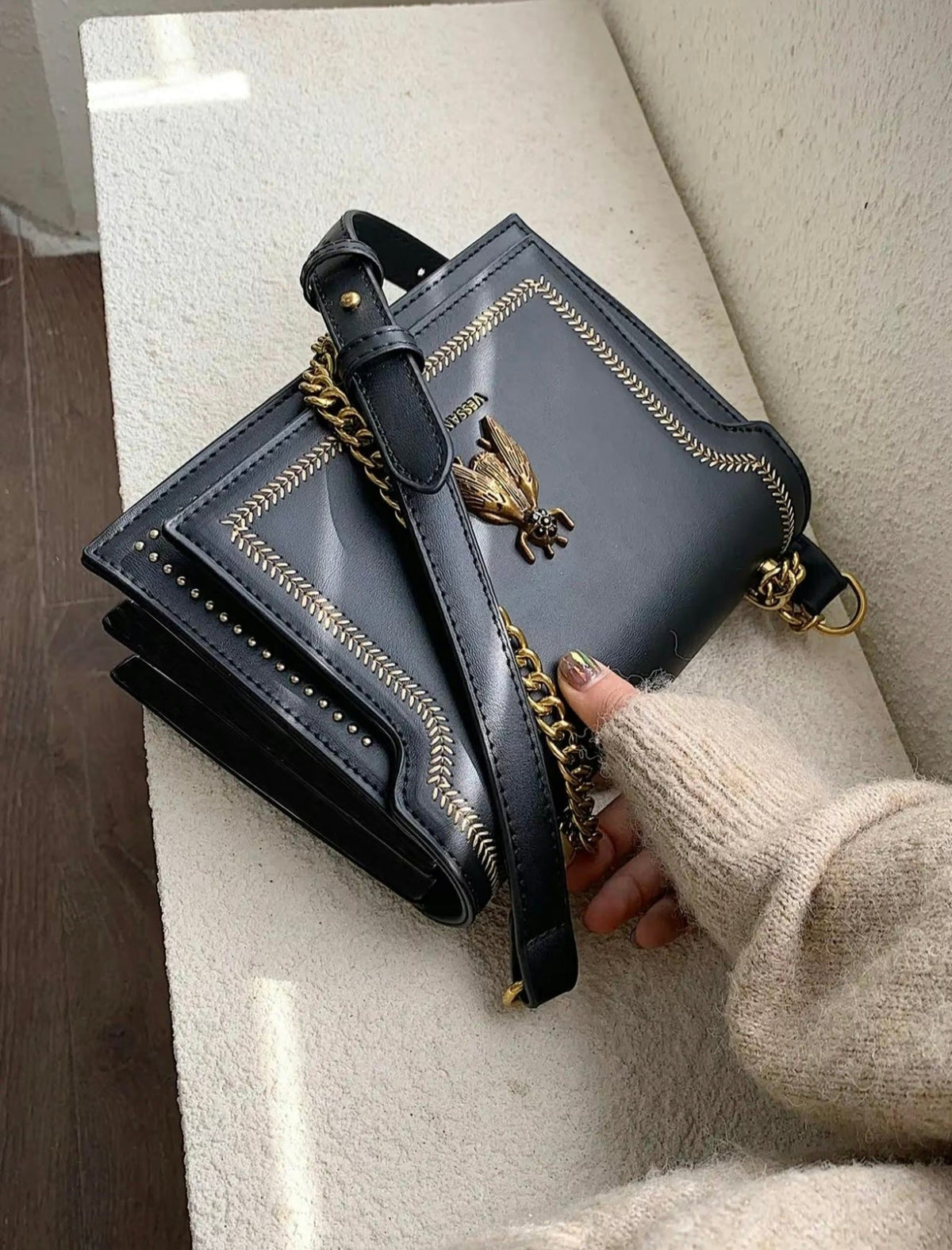 Simone chain bag in black, held with chain strap