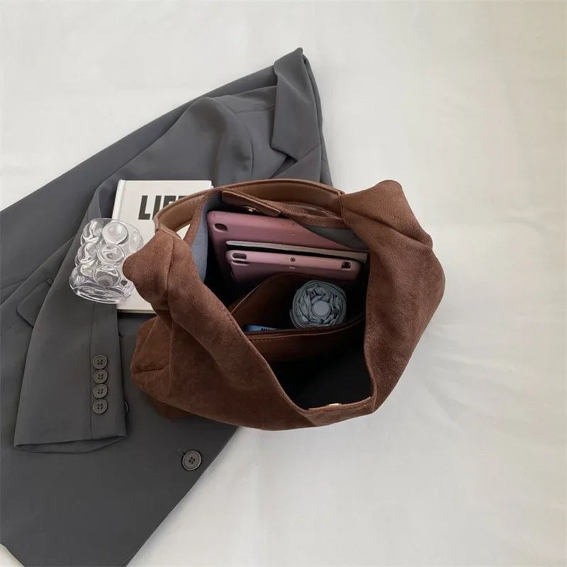 Ottilie brown shoulder bag holding laptop, phone and umbrella