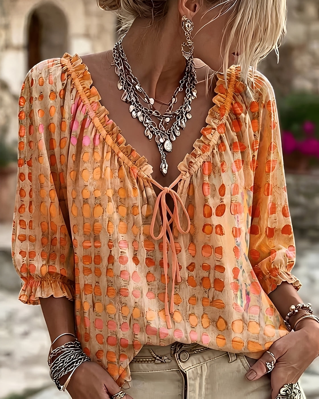 Candice polka-dot blouse in orange, front view on model