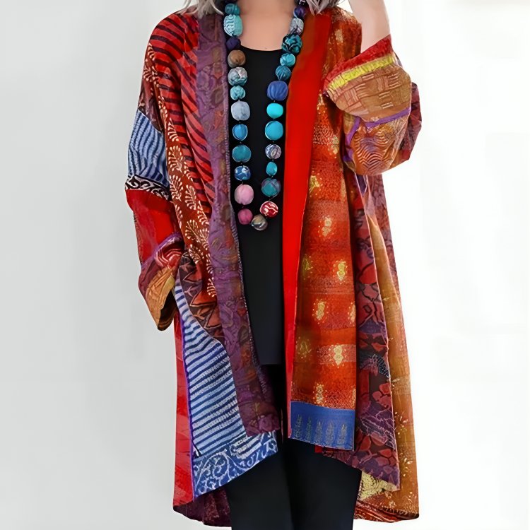 Dahlienne knit cardigan in red print, layered over black outfit