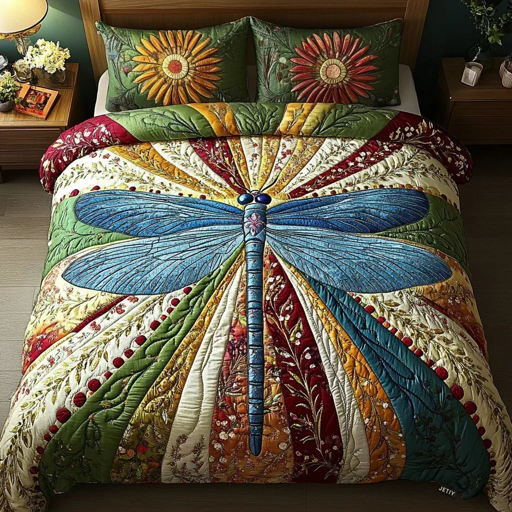 Golden Dragonfly quilted bedding set with blue dragonfly motif and floral pillowcases on a bed