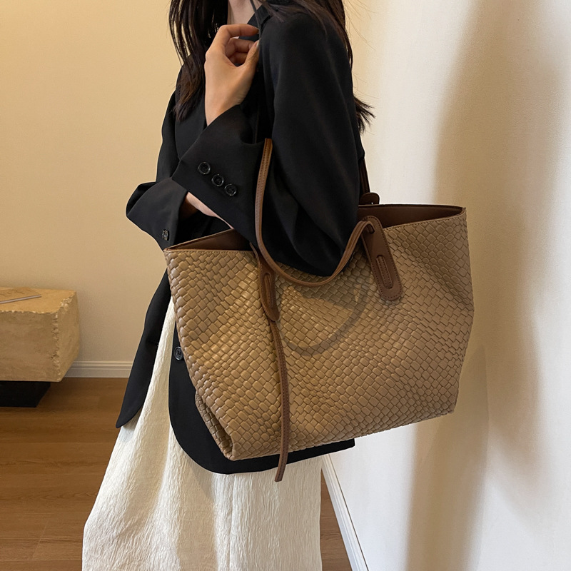 Arden woven tote bag in khaki carried on the shoulder