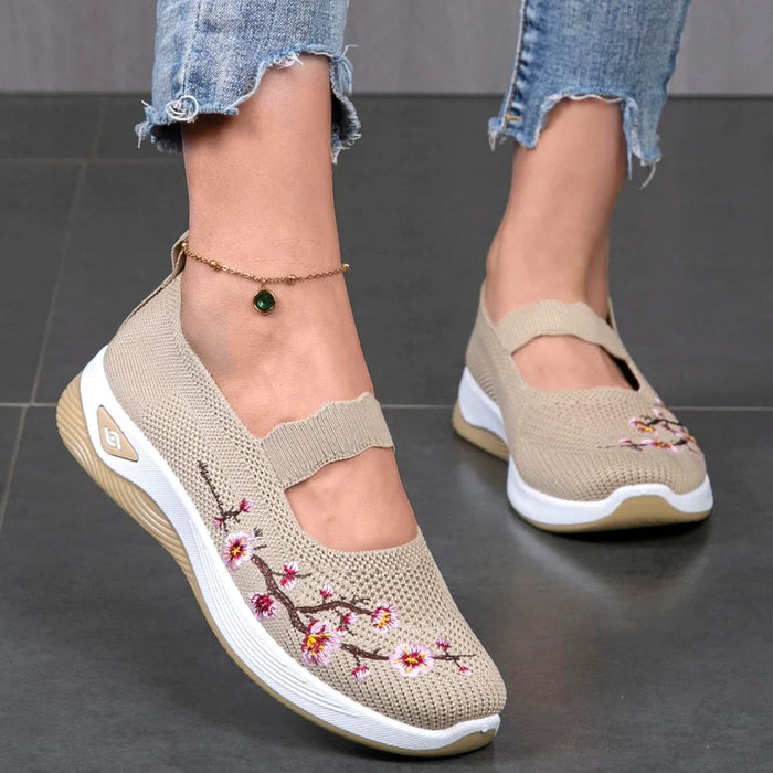 Leona slip-on orthopaedic shoes in beige with embroidered blossom branch, worn front view