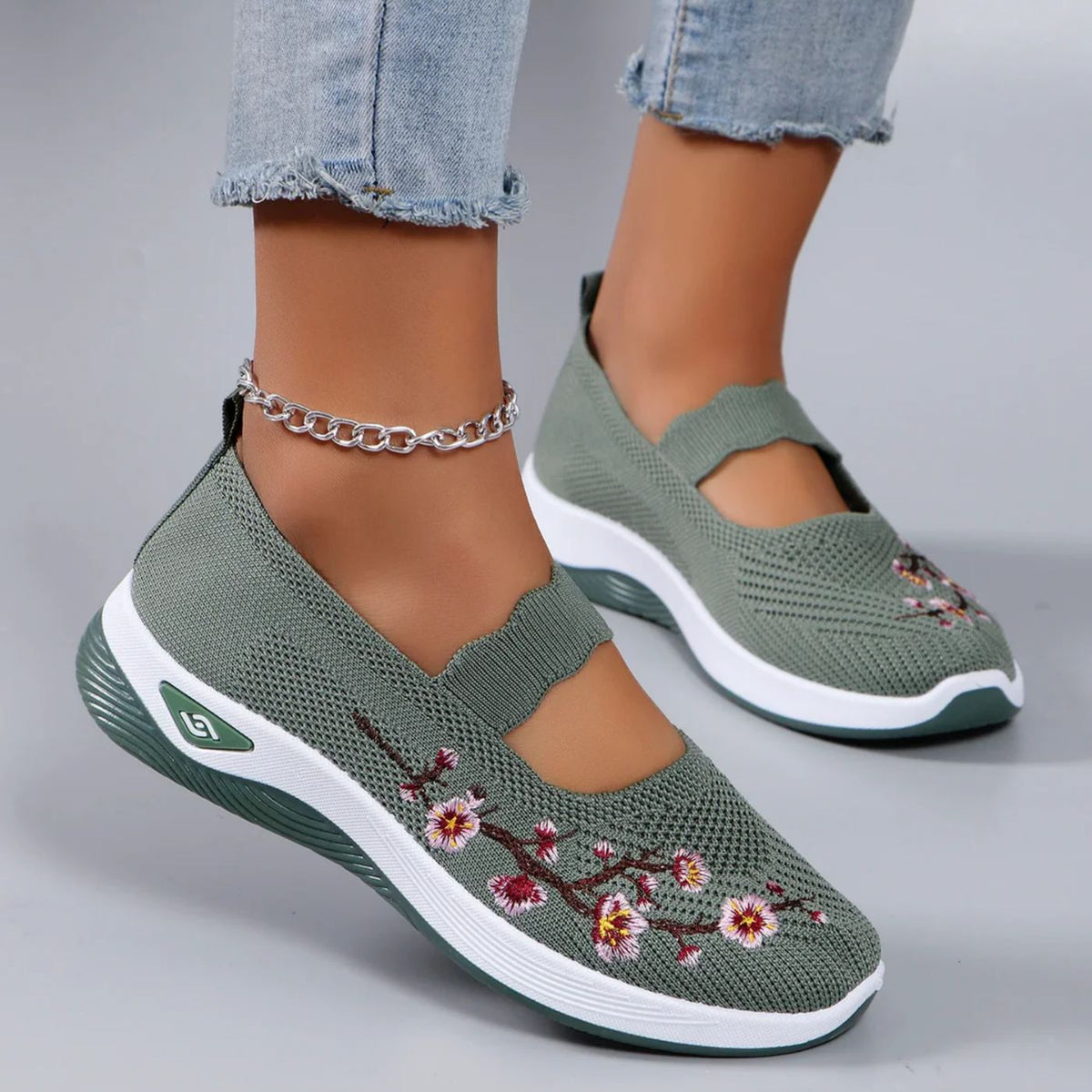 Leona slip-on orthopaedic shoes in green with blossom embroidery, worn front view