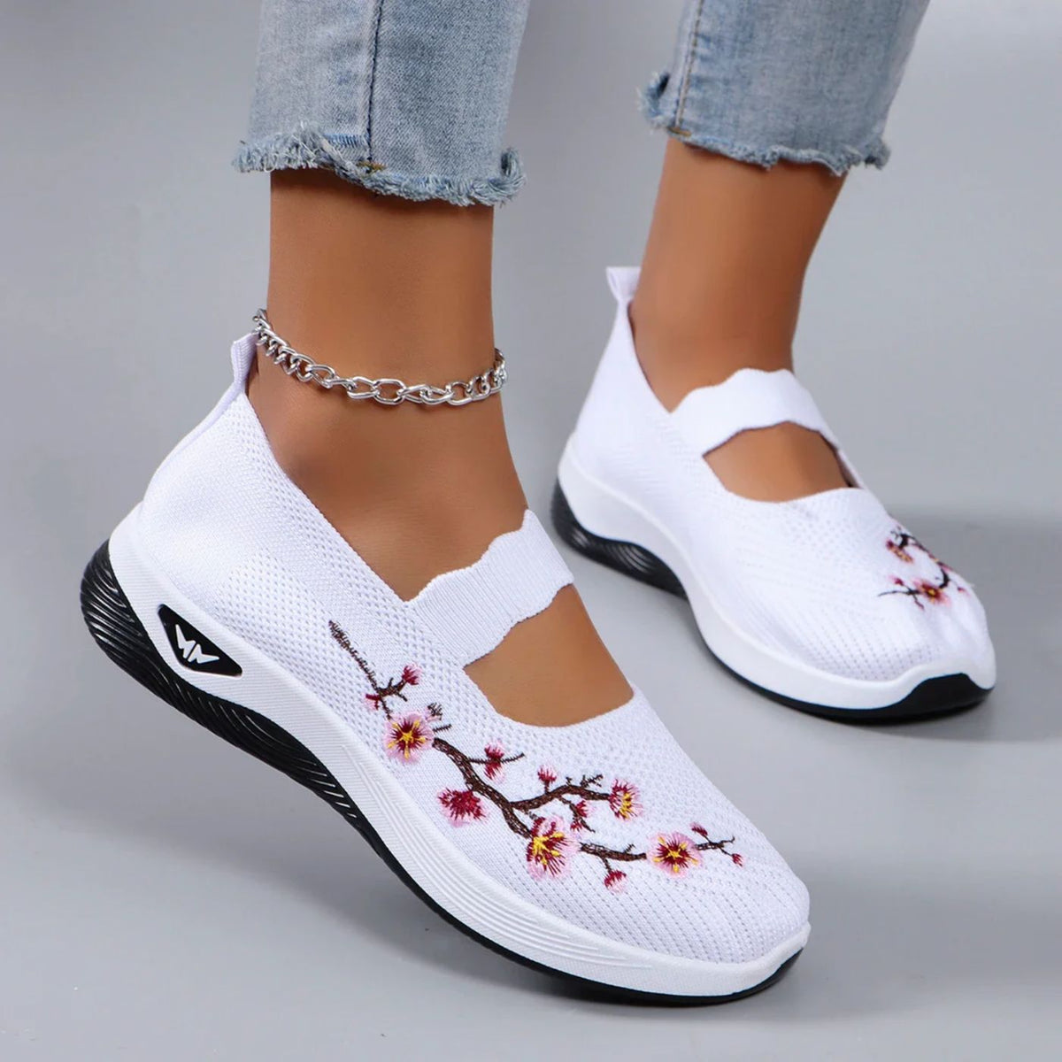 Leona slip-on orthopaedic shoes in white with floral embroidery, worn front view