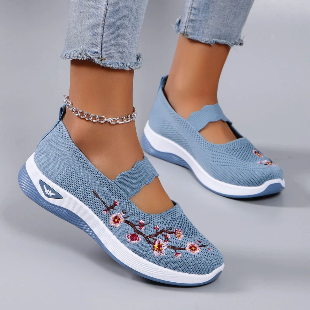 Leona slip-on orthopaedic shoes in blue with blossom embroidery, worn front view
