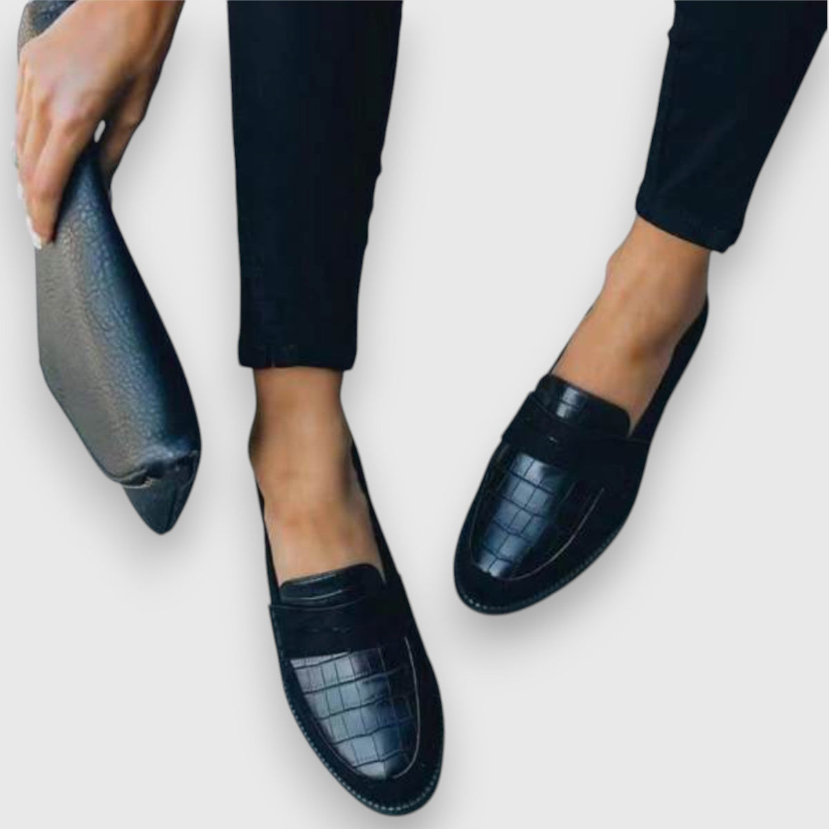 Juliette black loafers close-up showing croc-textured toe panel and flat sole