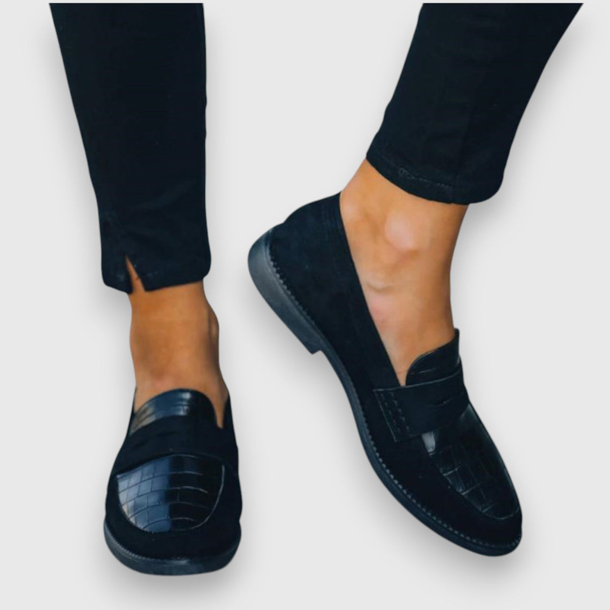 Juliette black loafers, side view worn with cropped black trousers