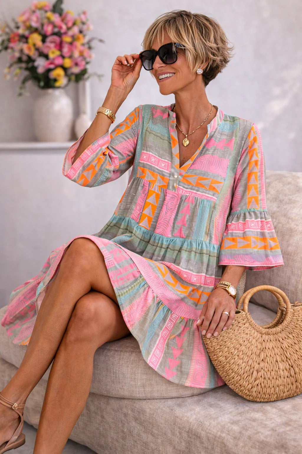 Aurabelle vintage-print dress in pink and orange, seated three-quarter view