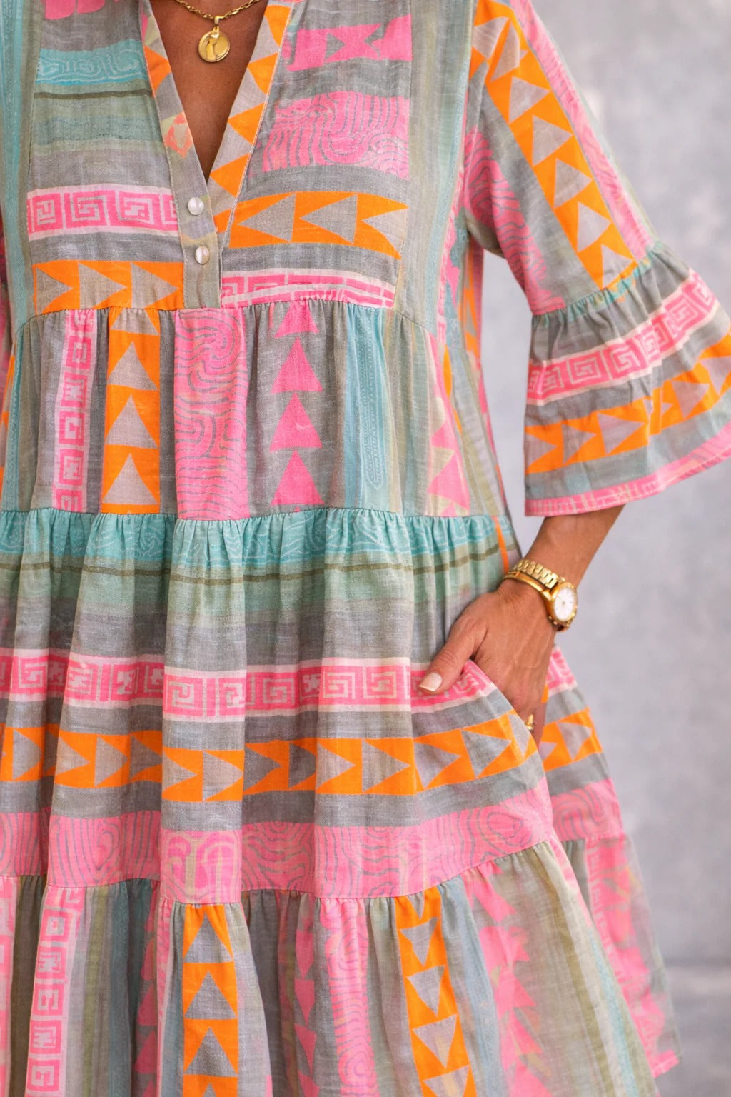 Close-up of Aurabelle dress buttoned notch neckline and geometric print