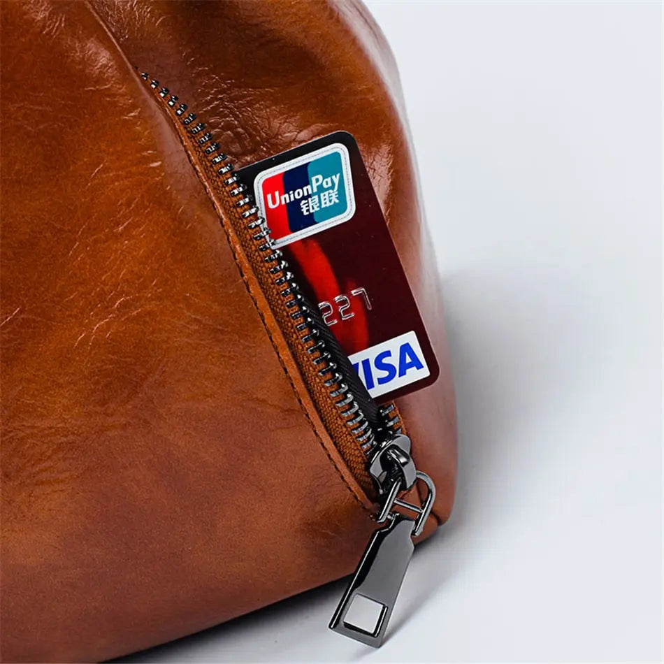 Liora luxe leather bag side zip pocket detail in brown