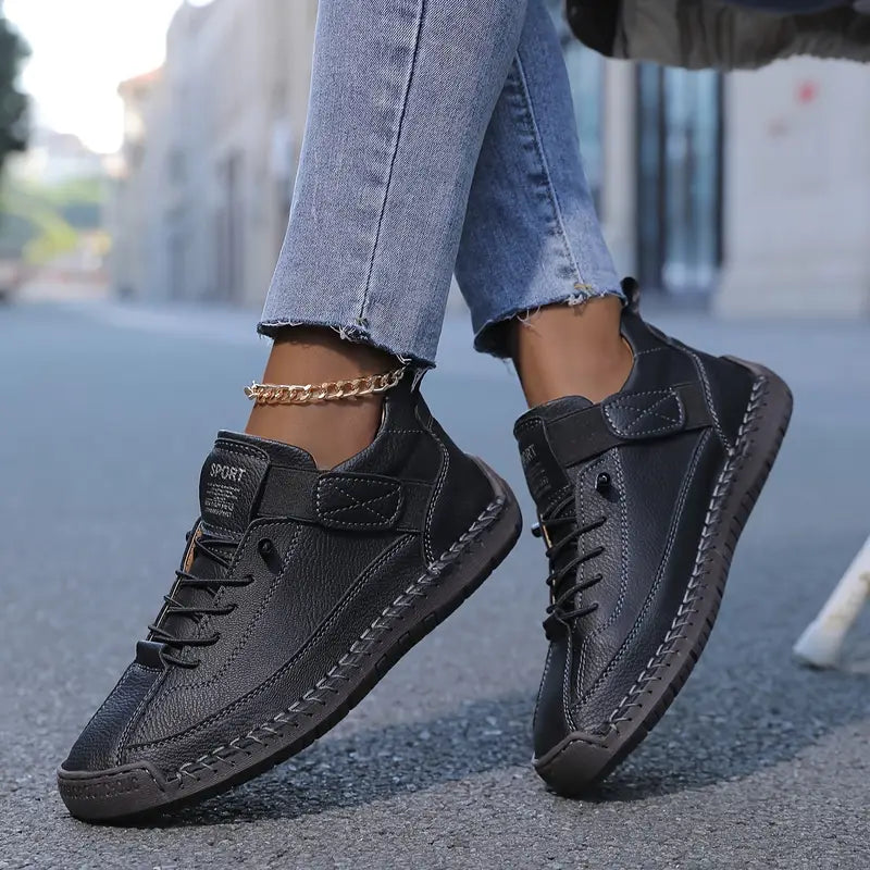 Mia orthopaedic trainers in black, worn side view on the street