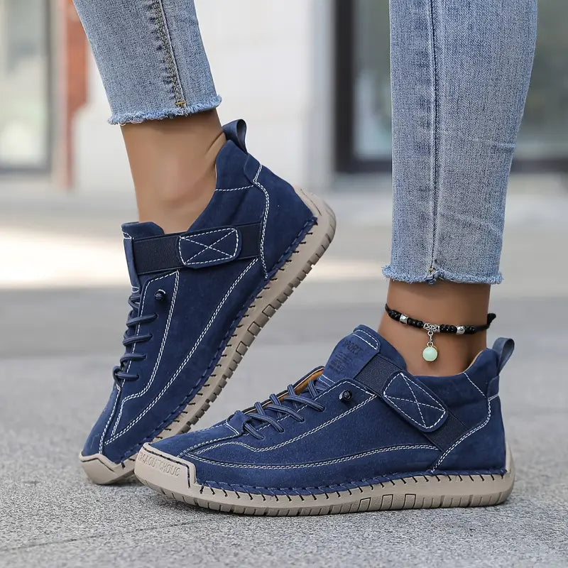 Mia orthopaedic trainers in navy, worn side view