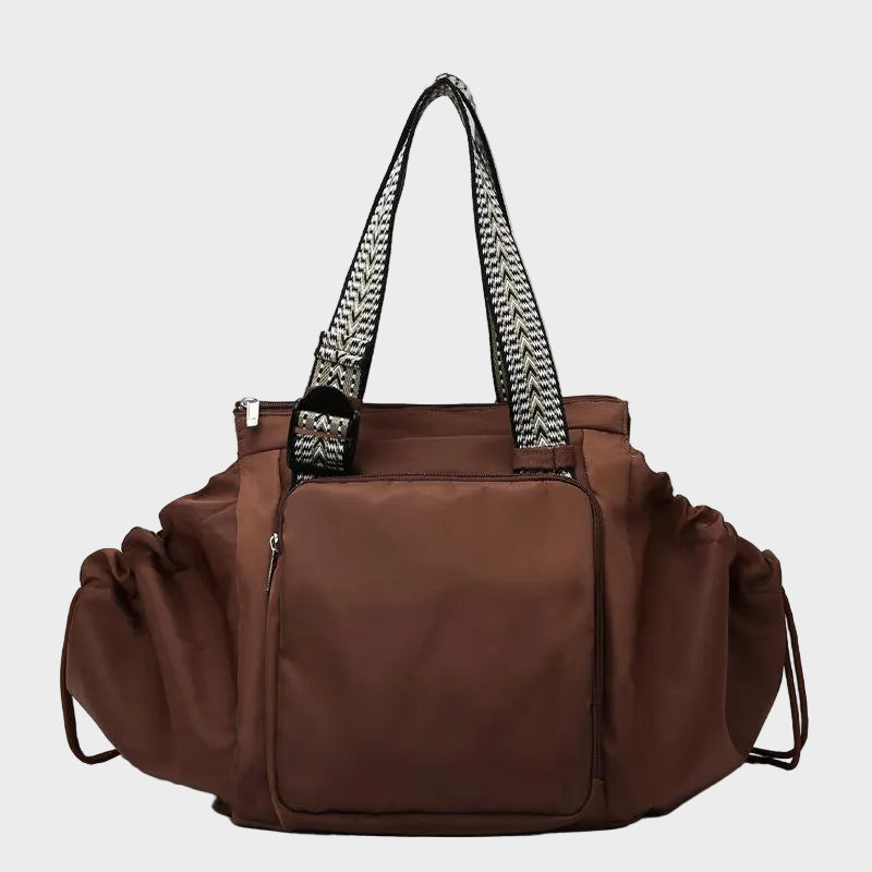 Ezra Pack Tote in brown with zipped front pocket, front view