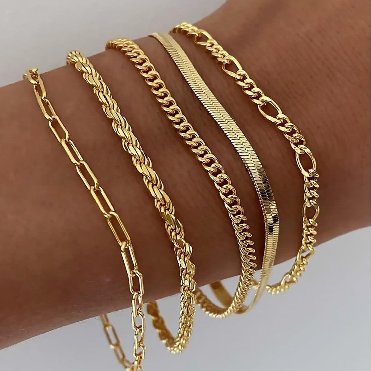 Juna gold bracelet set layered on the wrist, close side view