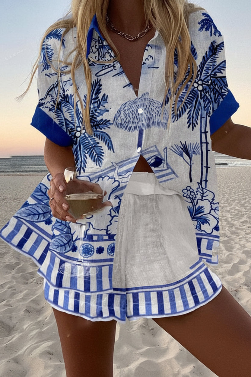 Paloma summer co-ord set in white with blue tropical print, front view on the beach