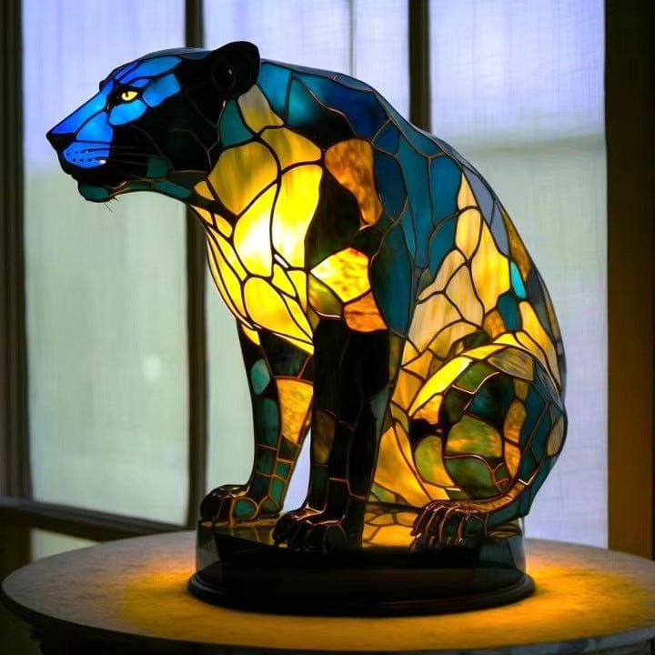 Midnight Panthera glow lamp in blue and amber stained-glass style, lit on a table