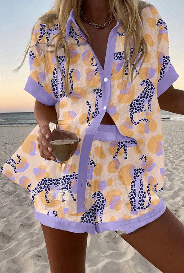 Serena summer co-ord set in cream with lavender cheetah print, front view on the beach