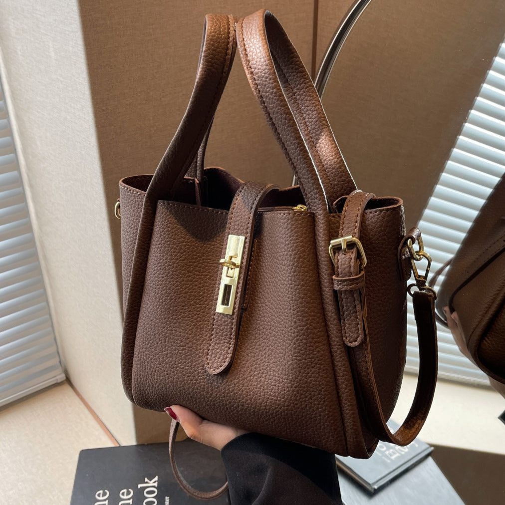 Gypsy retro crossbody handbag in dark brown, front view with gold turn-lock