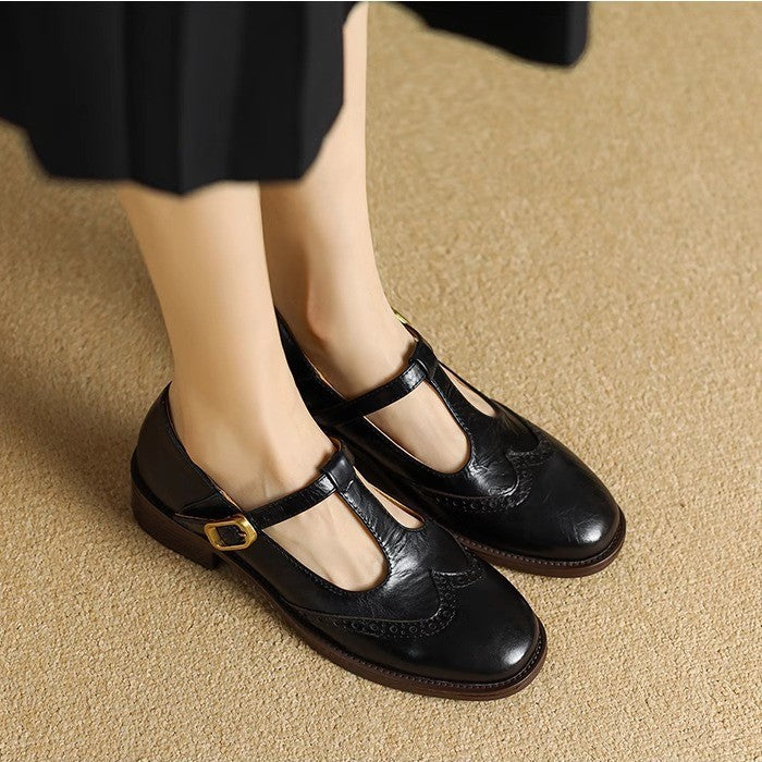 Ysolenne T-bar Mary Janes in black, worn front view