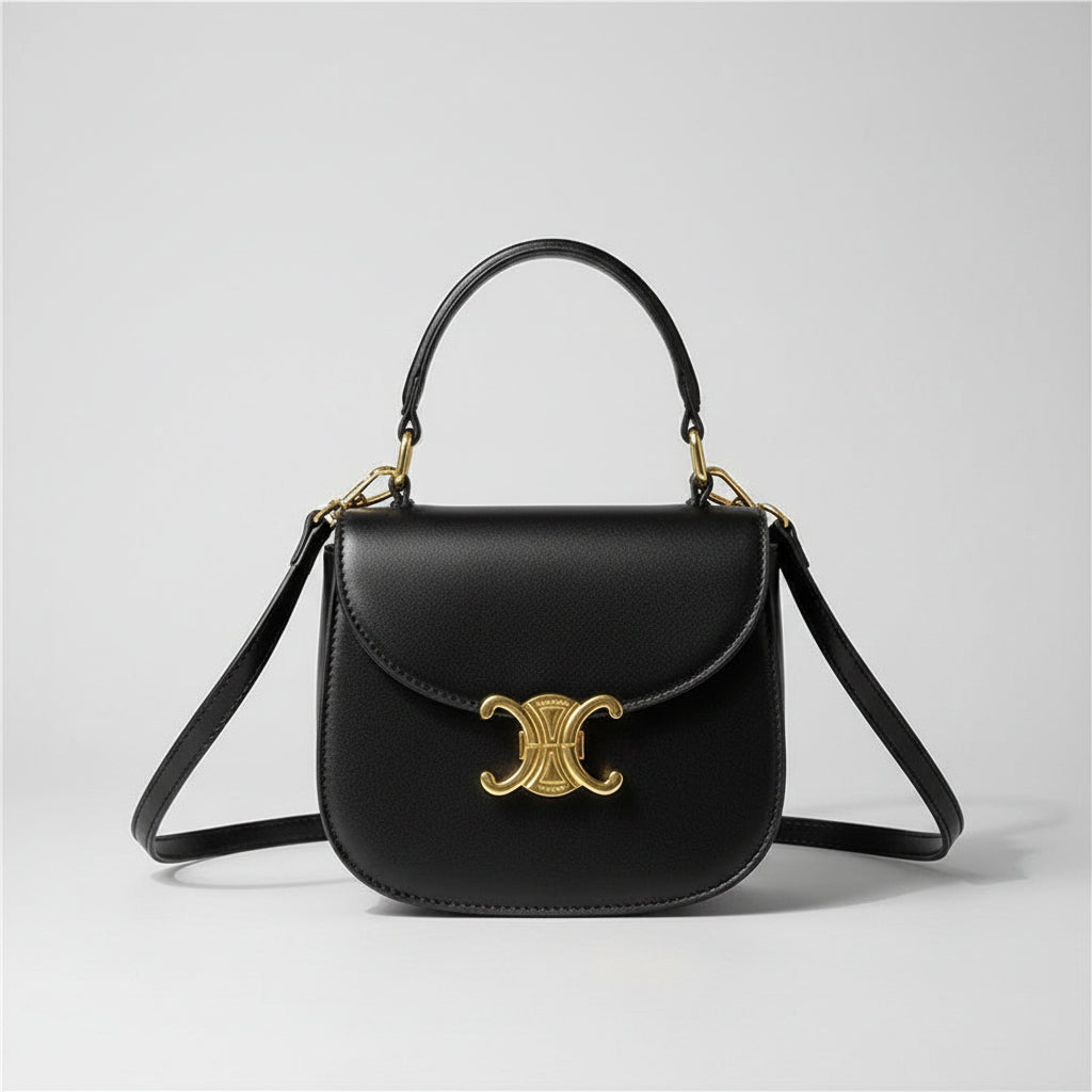 Mini crossbody bag in black with gold-tone clasp and long strap, front view