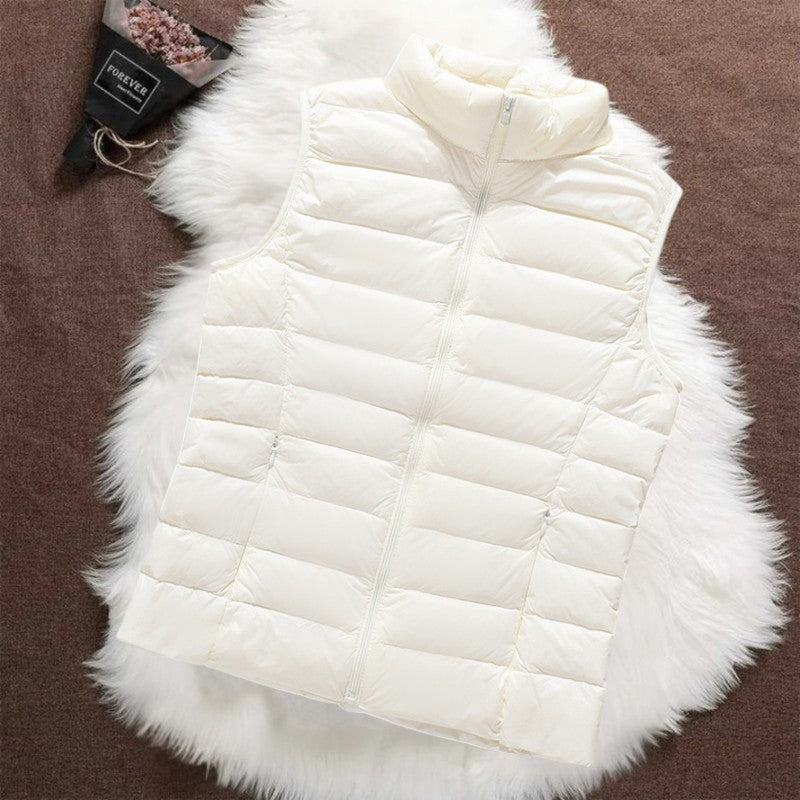 Isa padded gilet in white, quilted sleeveless front view with funnel collar and zip