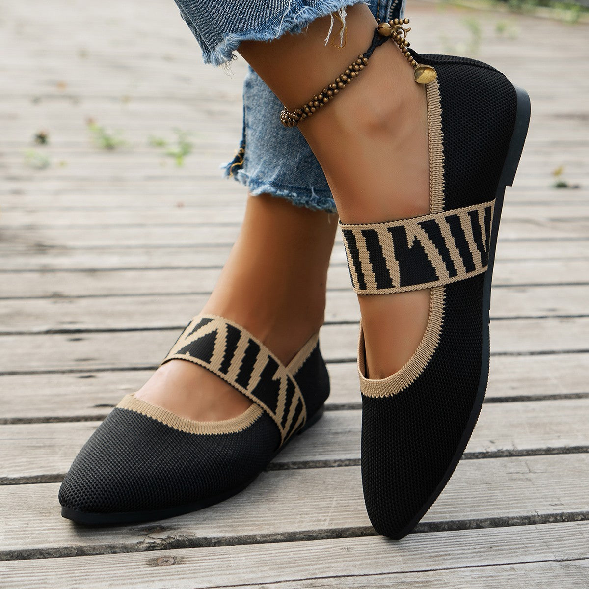 Ilyana patterned ballet flats in black, worn front view on decking