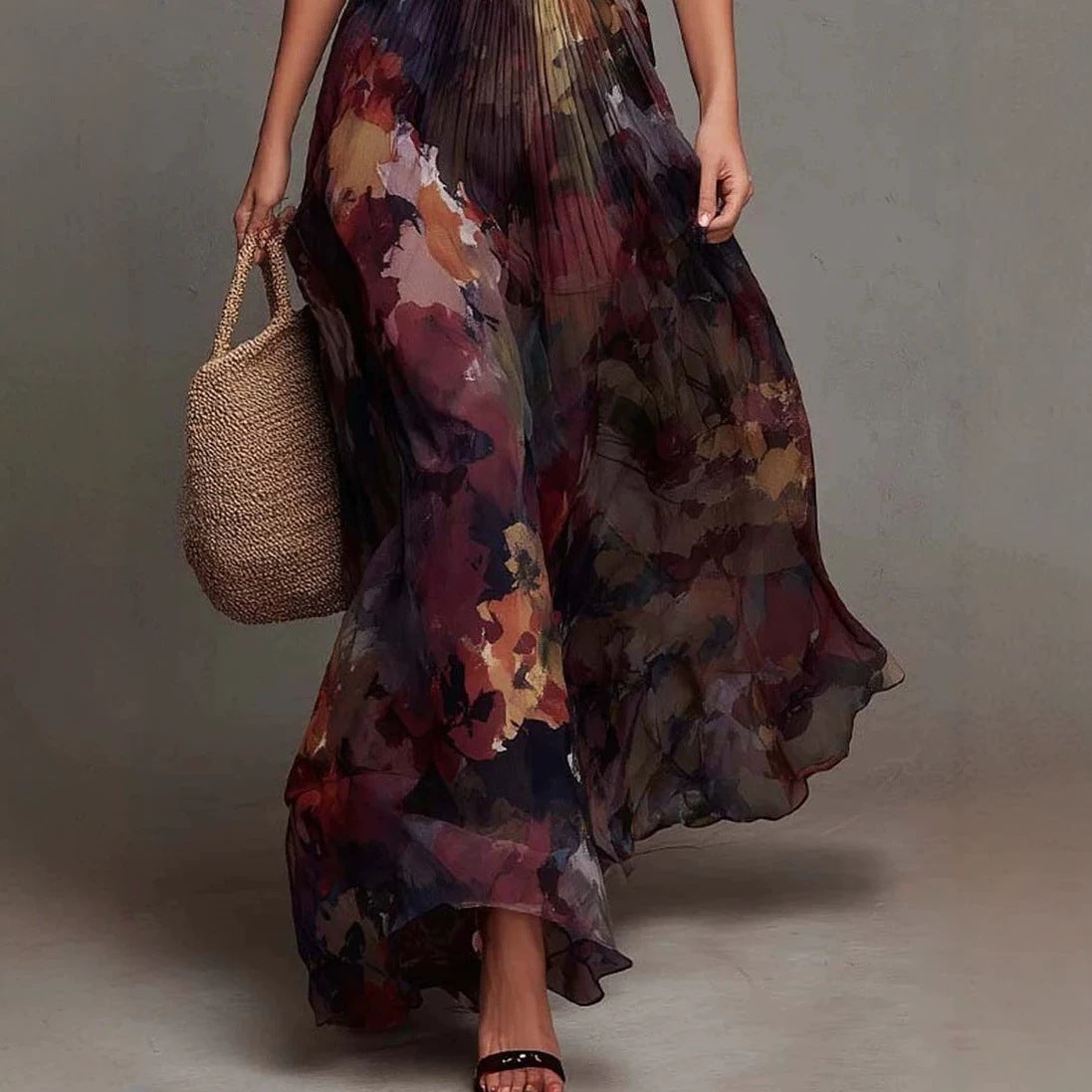 Detail of pleated chiffon skirt on reddish brown floral maxi dress