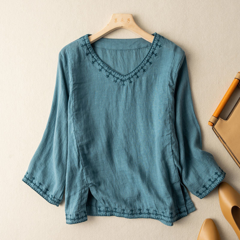 Anouk embroidered V-neck blouse in blue, front view on hanger