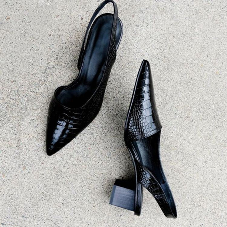 Victoria black croc-effect court shoes shown from above on stone