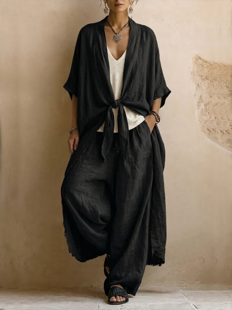 Black kimono and wide-leg trouser set styled with flat sandals