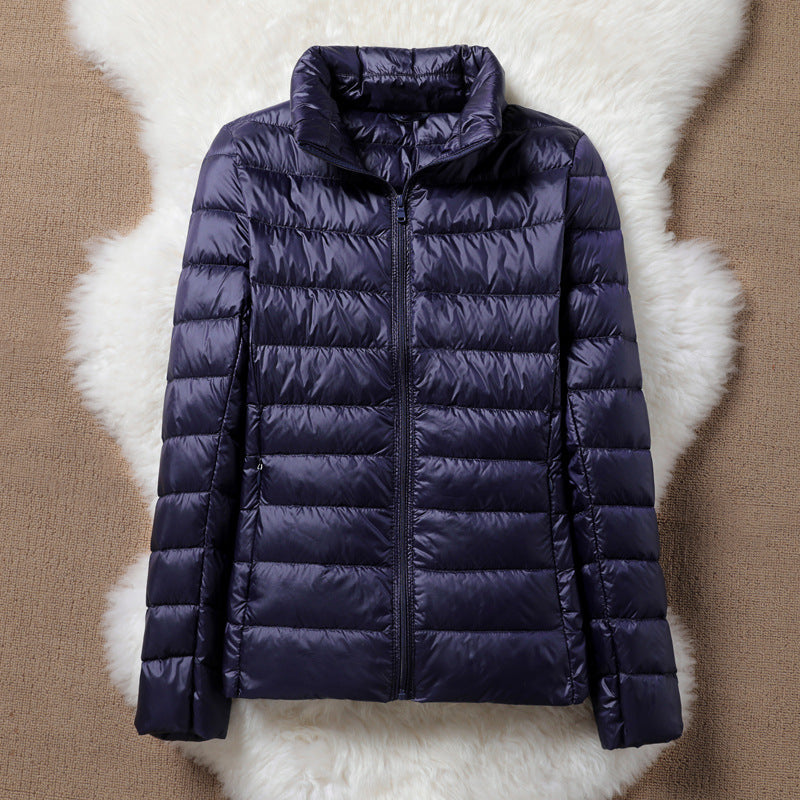 Ulla padded jacket in navy blue, flat product view with quilted channels and zip