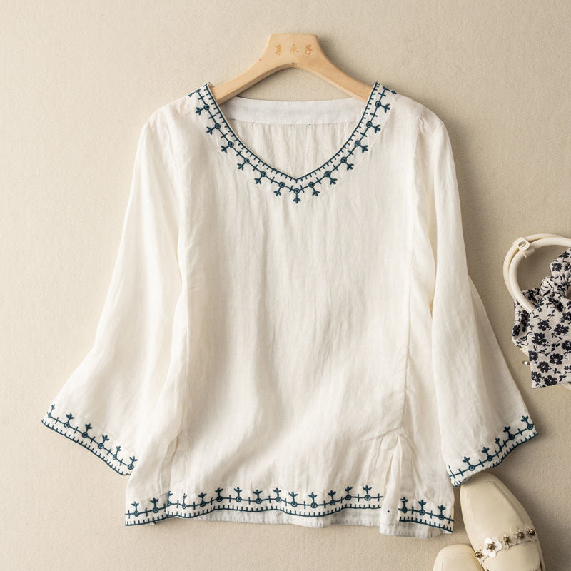 Anouk embroidered V-neck blouse in white, front view on hanger