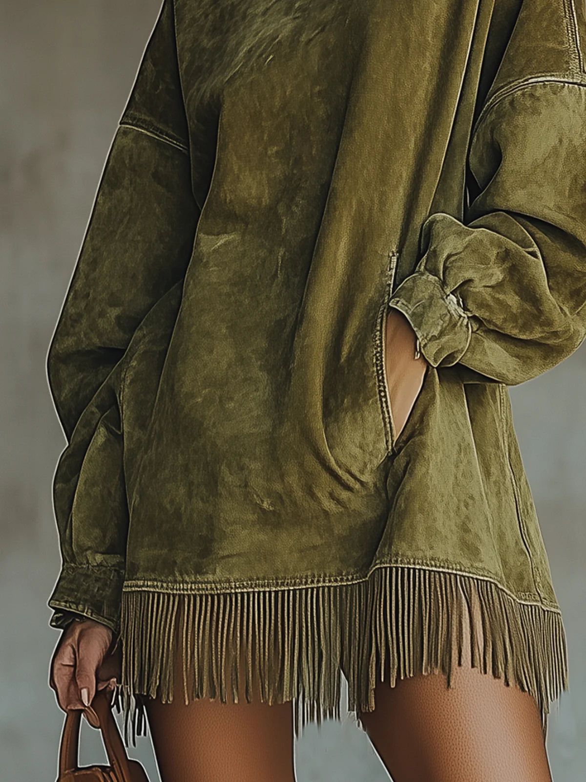 Sheril fringe dress in green, close-up of fringed hem and cuffed sleeve
