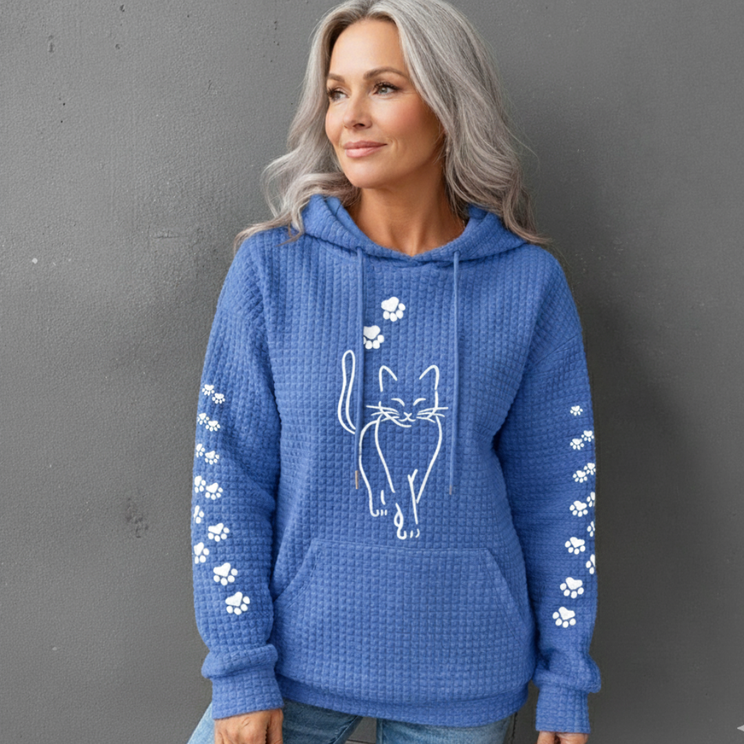 Savannah cat print hoodie in blue, worn full front view