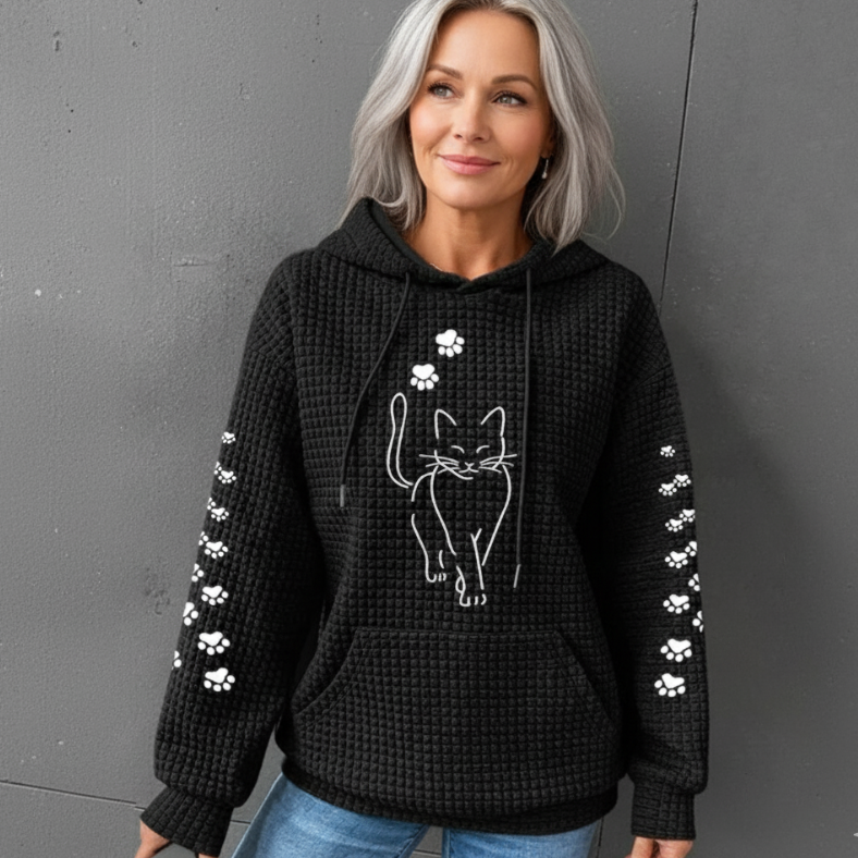 Savannah cat print hoodie in black, front view worn with jeans