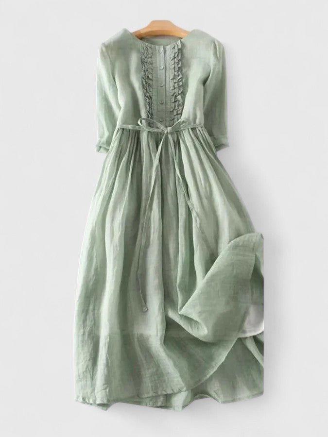 Kathryn ruffle-bib tie-waist dress in sage green on a hanger
