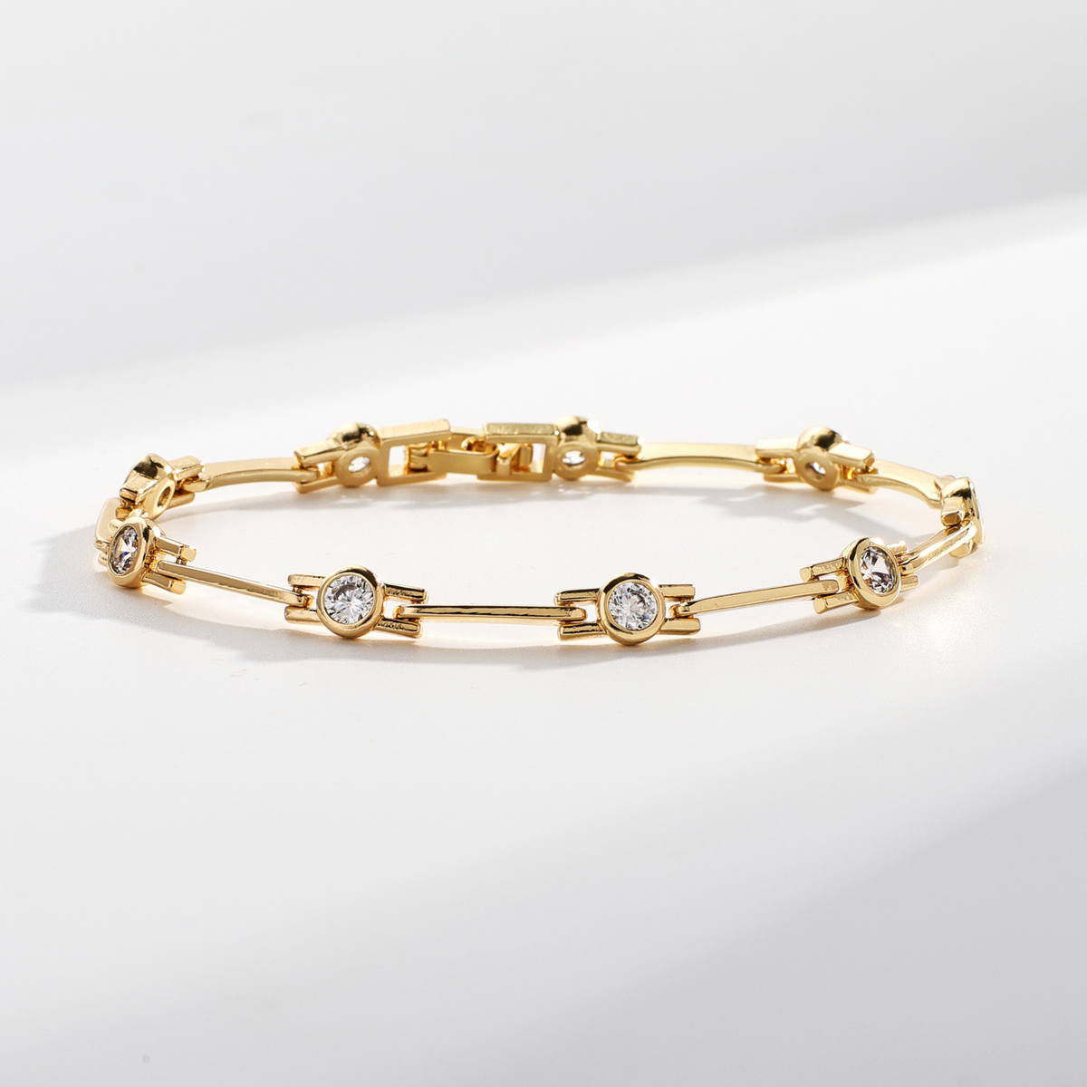 Refined gold bracelet with bezel-set sparkling zirconias, angled product view