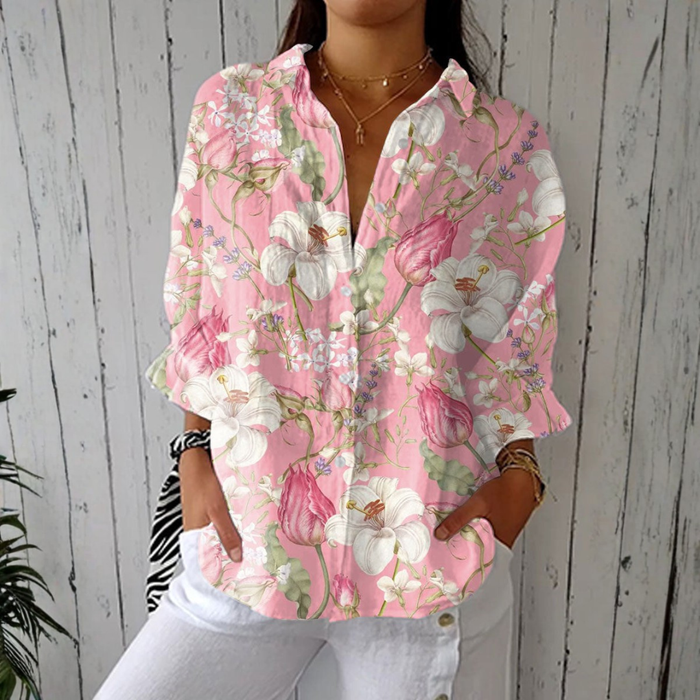 Nicole elegant floral blouse in pink, front view worn with white trousers
