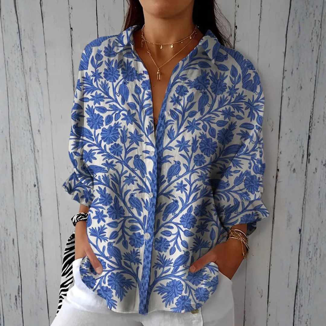 Elise garden birds blouse in blue and cream print, front view worn with white trousers