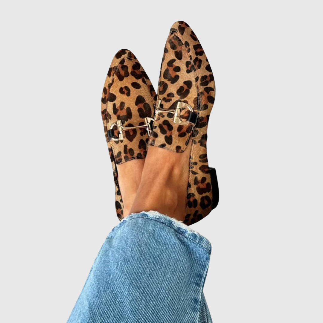 Penelope leopard print loafers with gold snaffle trim, worn close-up view