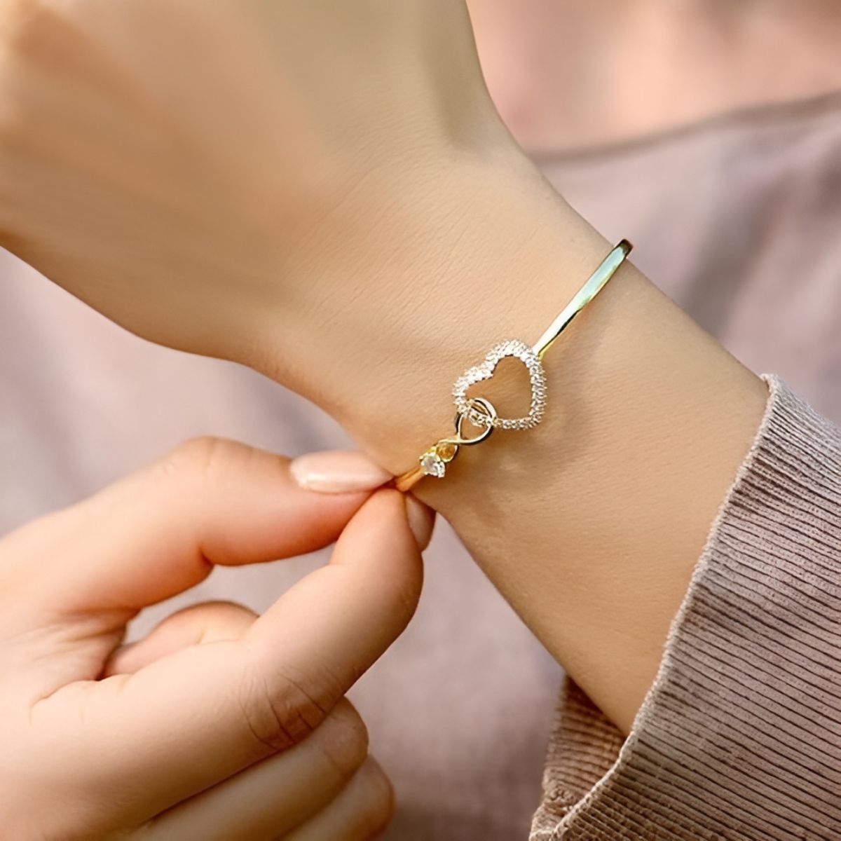 Endless Love gold bracelet fastened on the wrist, close-up view