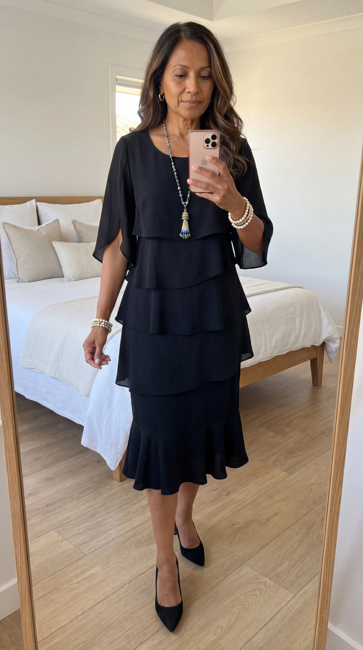 Lily tiered ruffled midi dress in black, mirror view showing ruffled hem